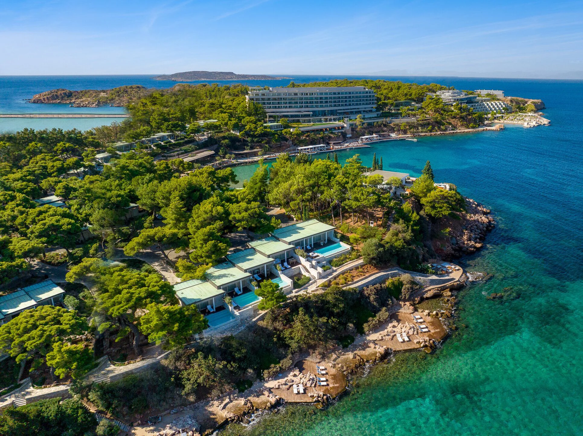 Four Seasons Astir Palace surrounded by pines and clear water on the Astir Peninsula