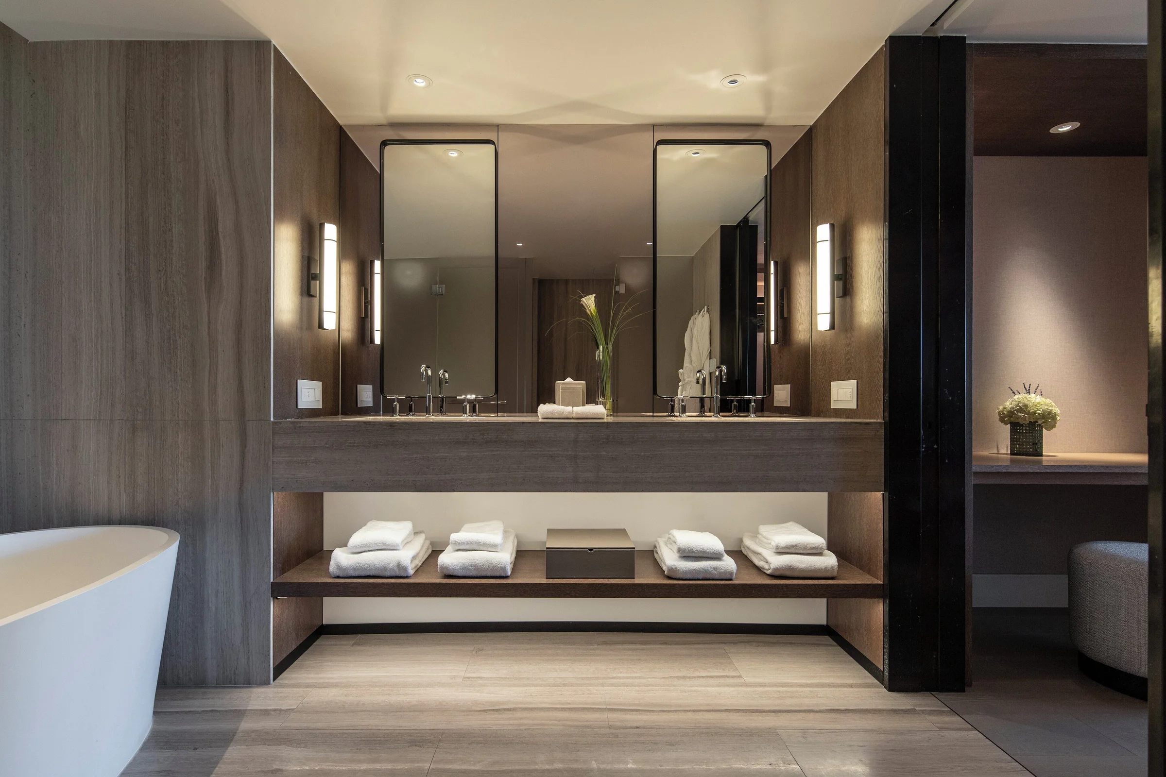 Contemporary marble bathroom with twin vanities and a deep soaking tub