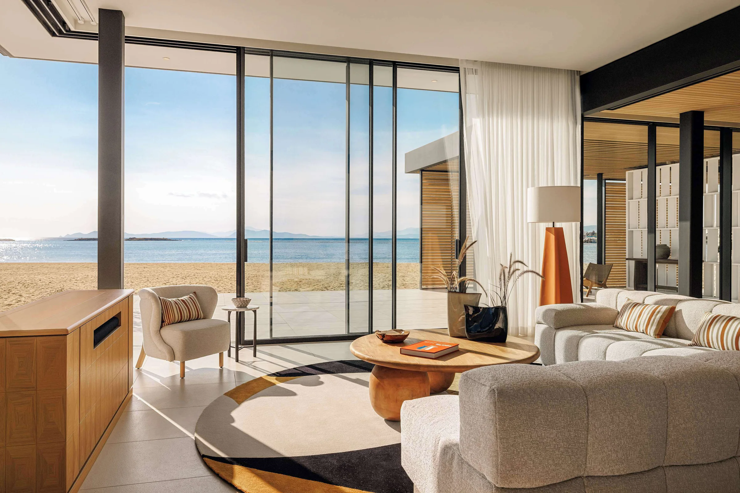 Contemporary beachfront villa living room with floor-to-ceiling sea views