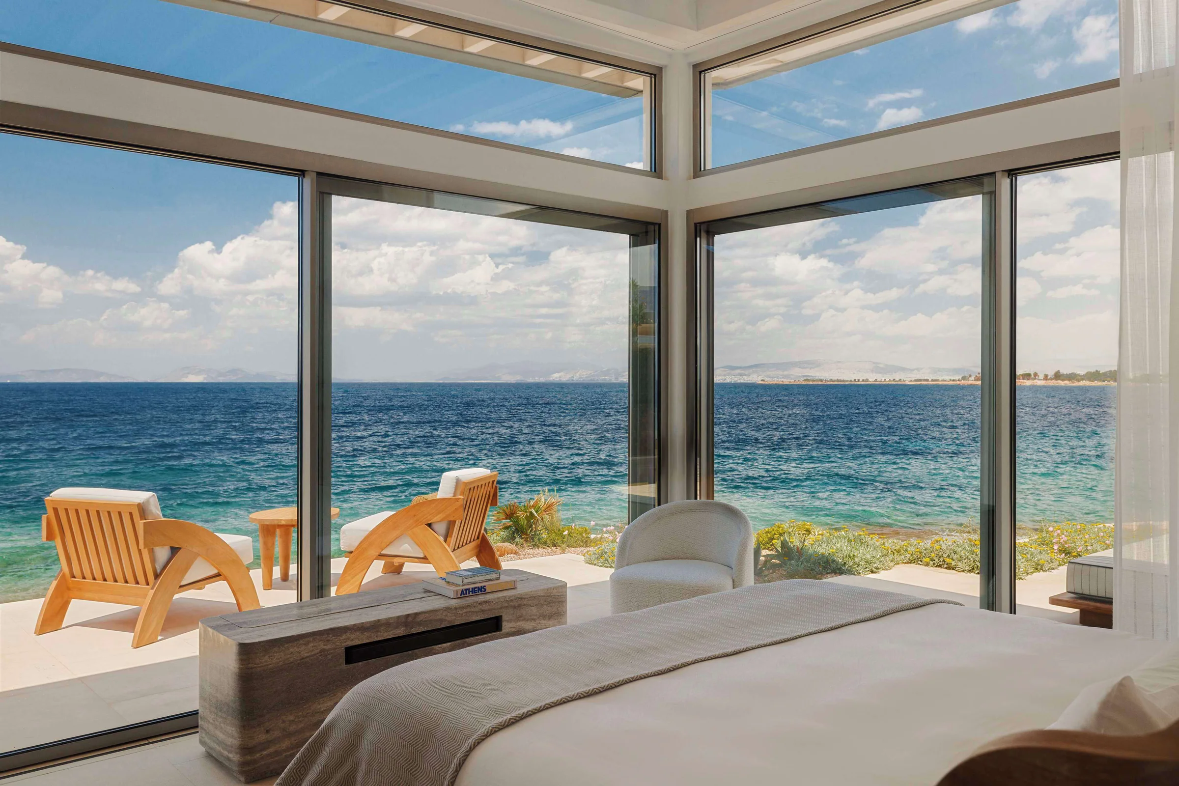 Sea-view bedroom opening onto a waterfront terrace