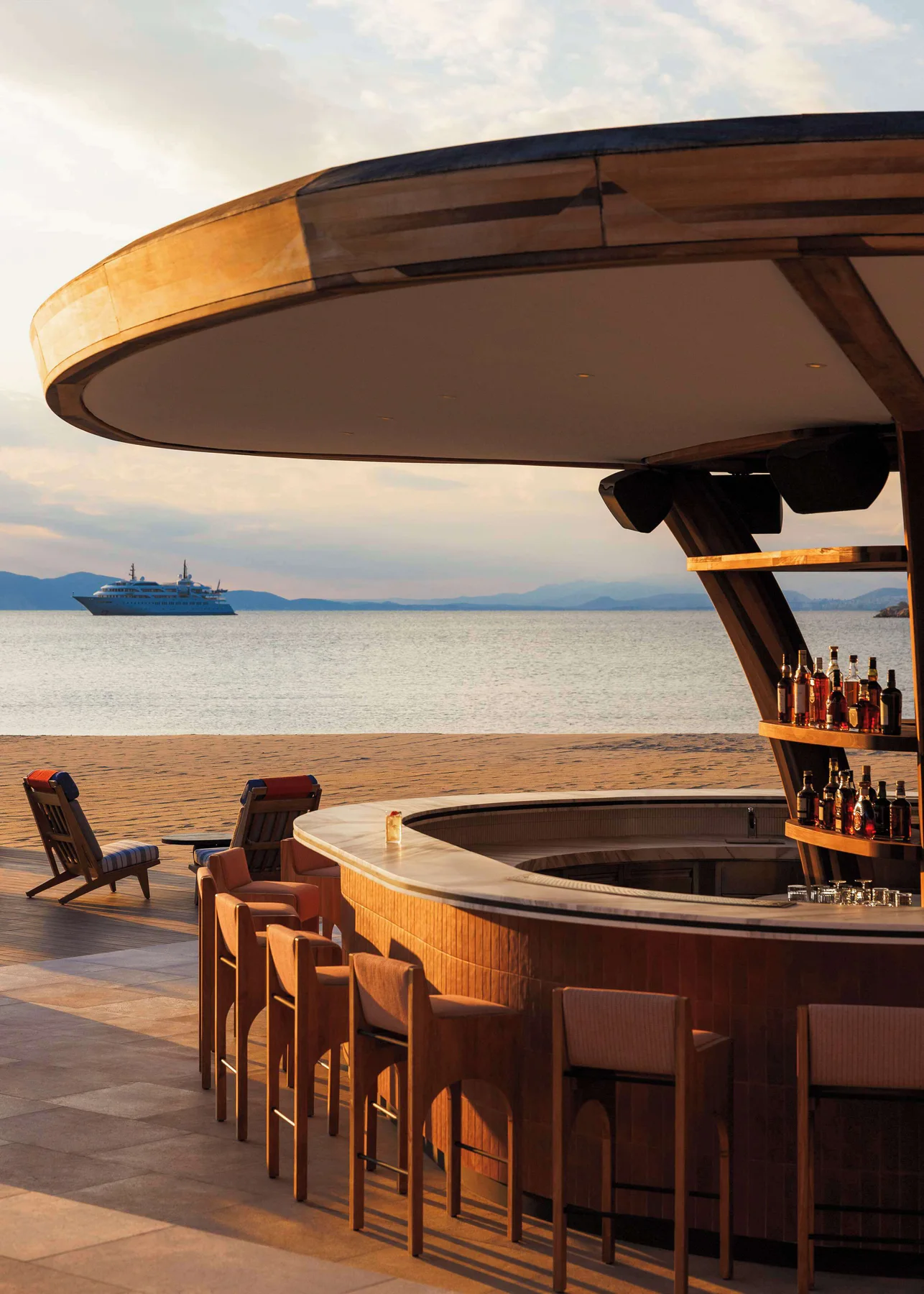 Curved waterfront bar glowing in the late-afternoon sun